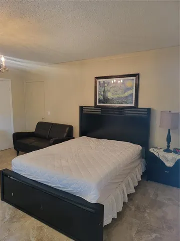 a bedroom with bed and window