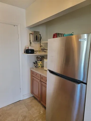 a white refrigerator freezer sitting in a kitchen