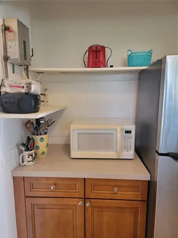 a kitchen with a refrigerator and cabinets