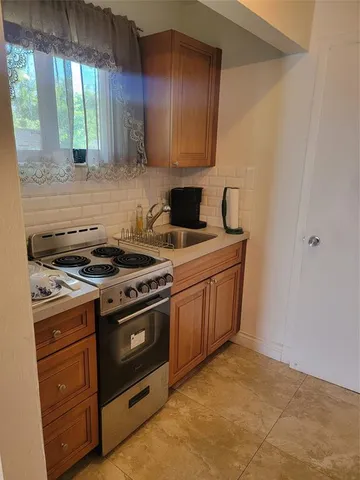 a kitchen with a stove and a sink