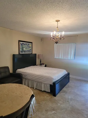 a bedroom with bed and window