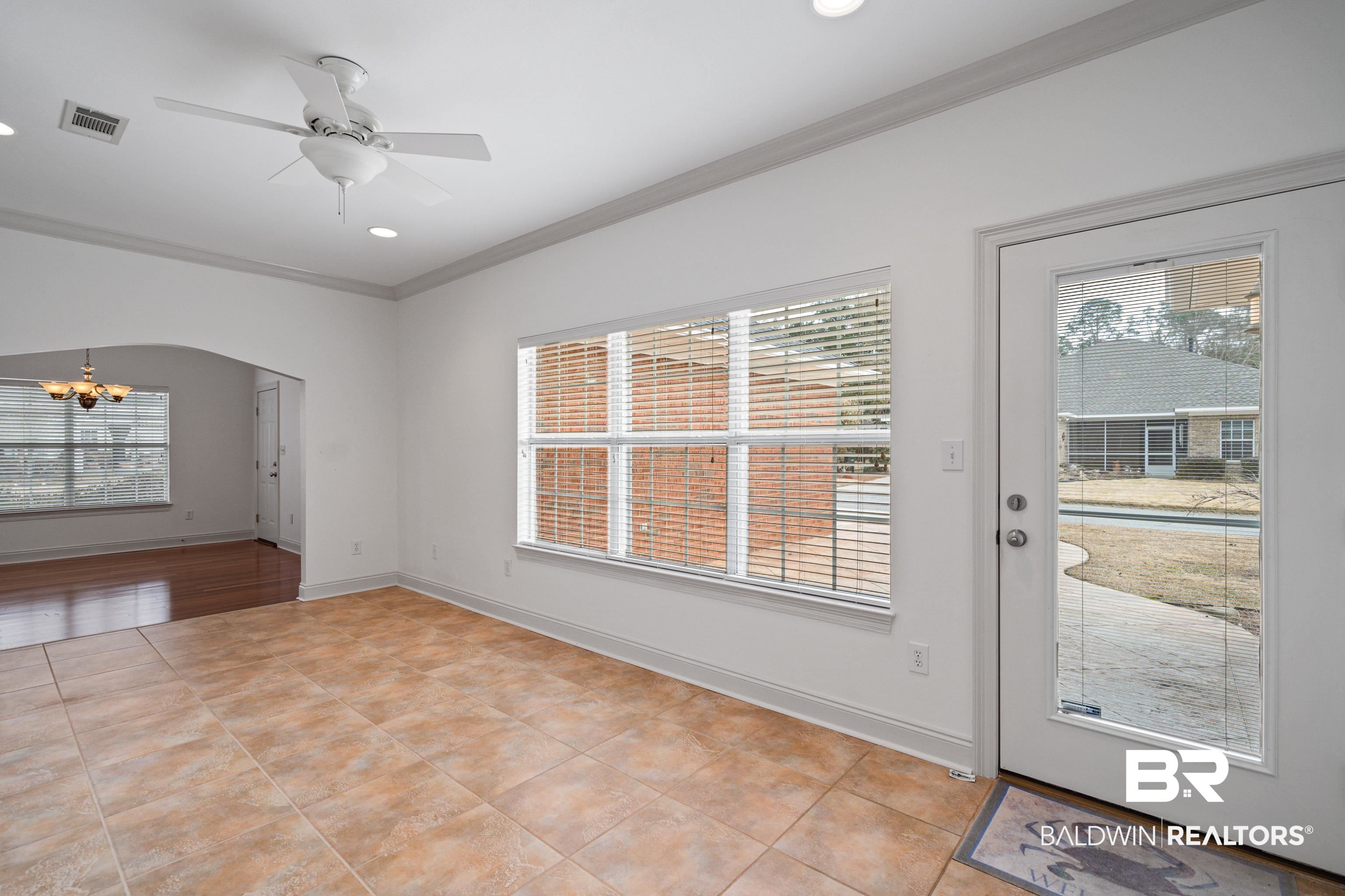 404 Savannah Lane Foley, AL 36535 - Photo 11 of 29 Interior space with arched walkways, a wealth of natural light, visible vents, and crown molding