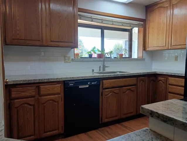 a view of kitchen with sink and a window