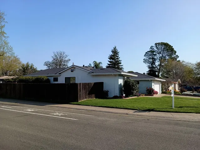 a kitchen with granite countertop wood cabinets and a sink