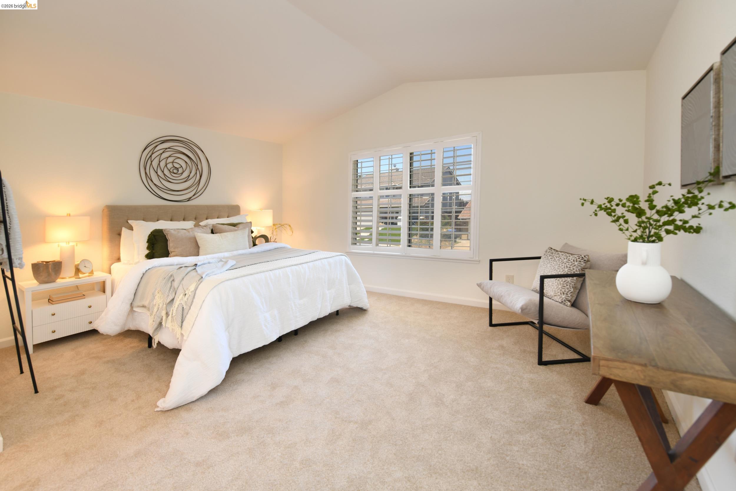 512 Burdick Drive Bay Point, CA 94565 - Photo 26 of 50 Expansive bedroom featuring vaulted ceilings, light-colored carpet flooring, a large window with white plantation shutters, and light neutral wall tones