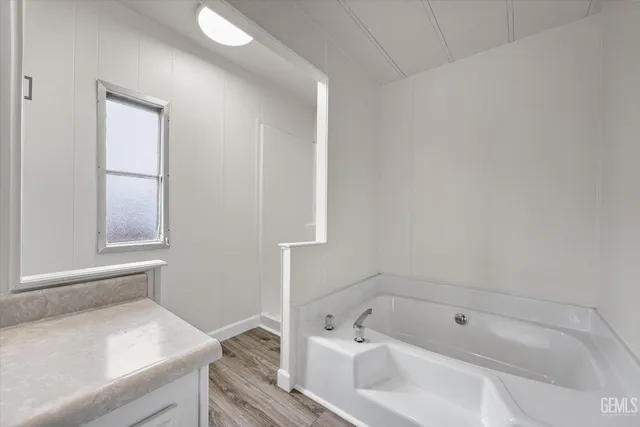 a bedroom with a bed and a potted plant