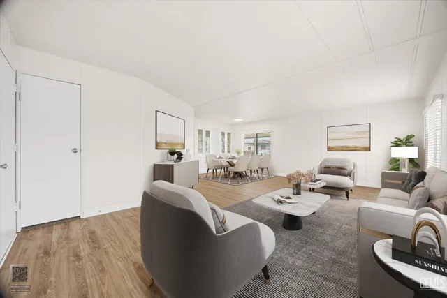 a living room with furniture a dining table and a potted plant