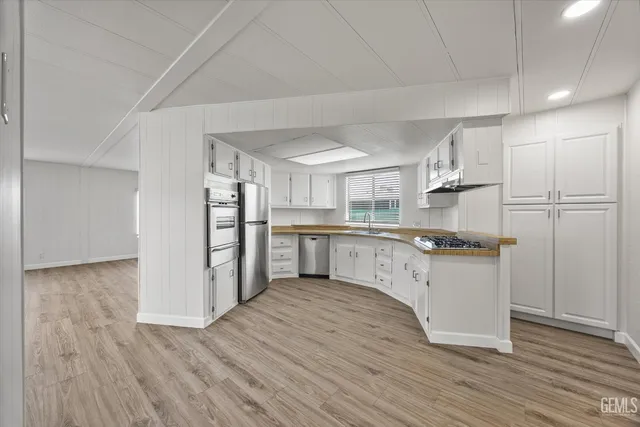 a kitchen with granite countertop a sink stove and refrigerator