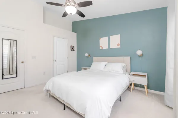 a bedroom with a bed and a chandelier