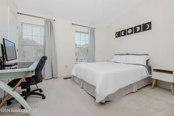 a bedroom with a bed a desk and chair