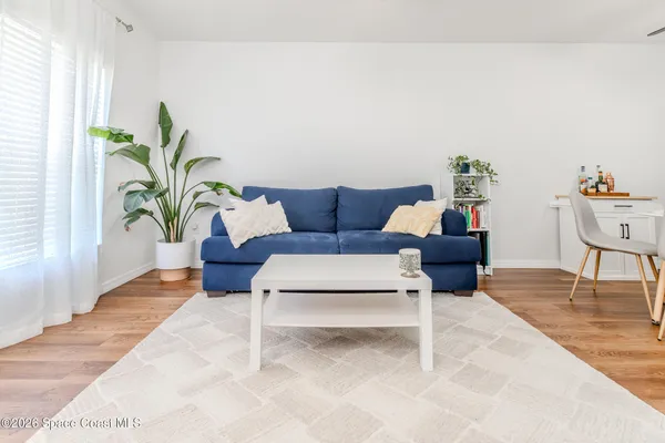 a living room with furniture and a potted plant