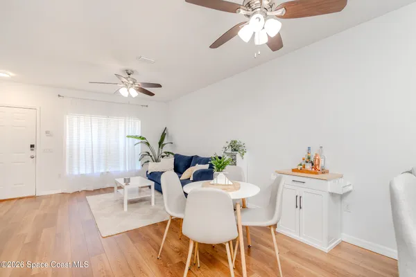 a view of a dining room with furniture and wooden floor
