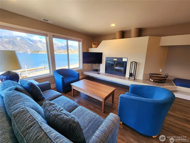 a living room with furniture a large window and a couch