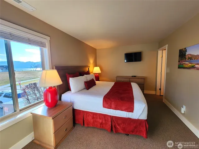 a bedroom with bed and window