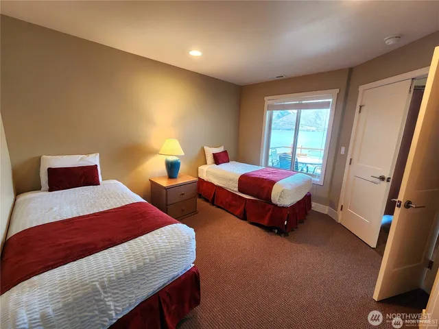 a bedroom with two beds and a window