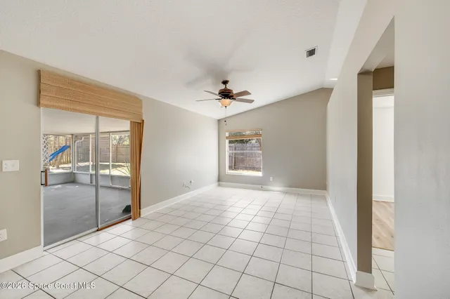 a view of an empty room with a kitchen