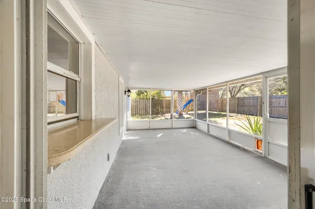 a view of a livingroom with an empty space and a window