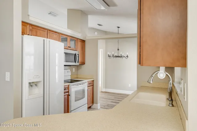a kitchen with stainless steel appliances granite countertop a refrigerator and a stove