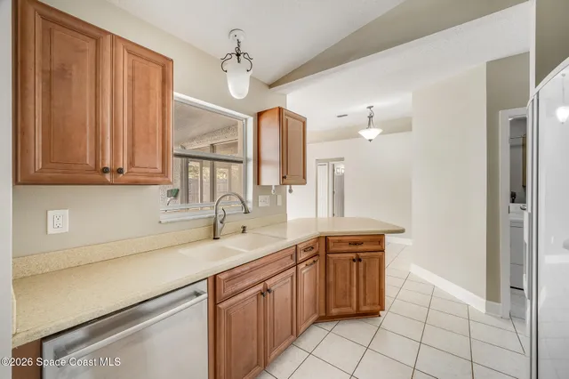 a kitchen with stainless steel appliances granite countertop a sink and dishwasher with white cabinets