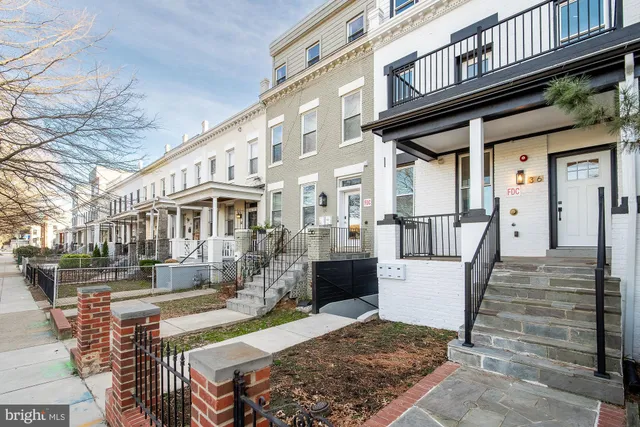 a view of a house with a wooden fence