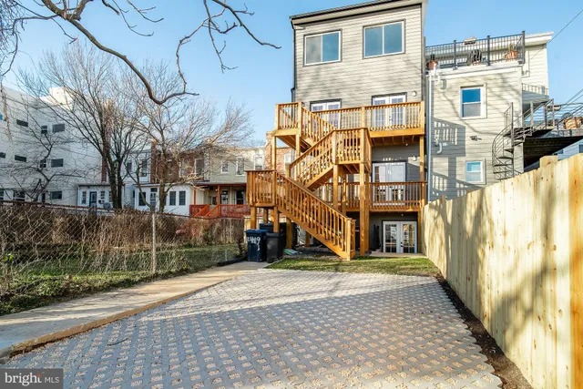 a view of a brick house with large windows