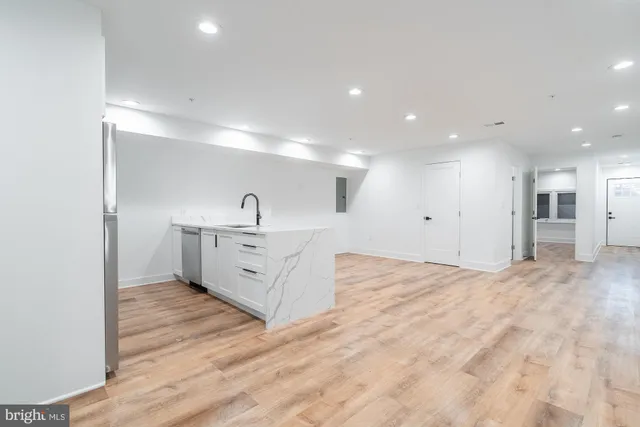 a kitchen with kitchen island a sink stainless steel appliances and cabinets
