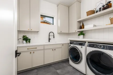 a view of a kitchen with sink washer and dryer