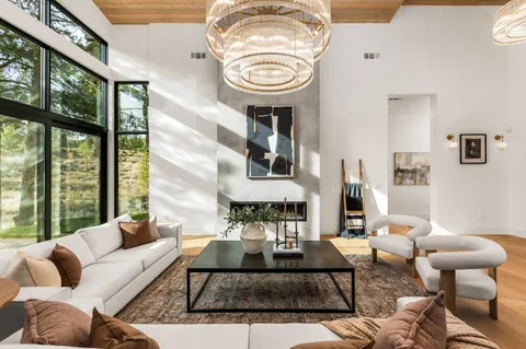 a living room with furniture a fireplace and a large window