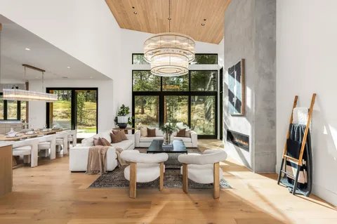 a very nice looking living room with a large window and chandelier