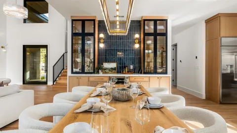 a living room with furniture and large windows