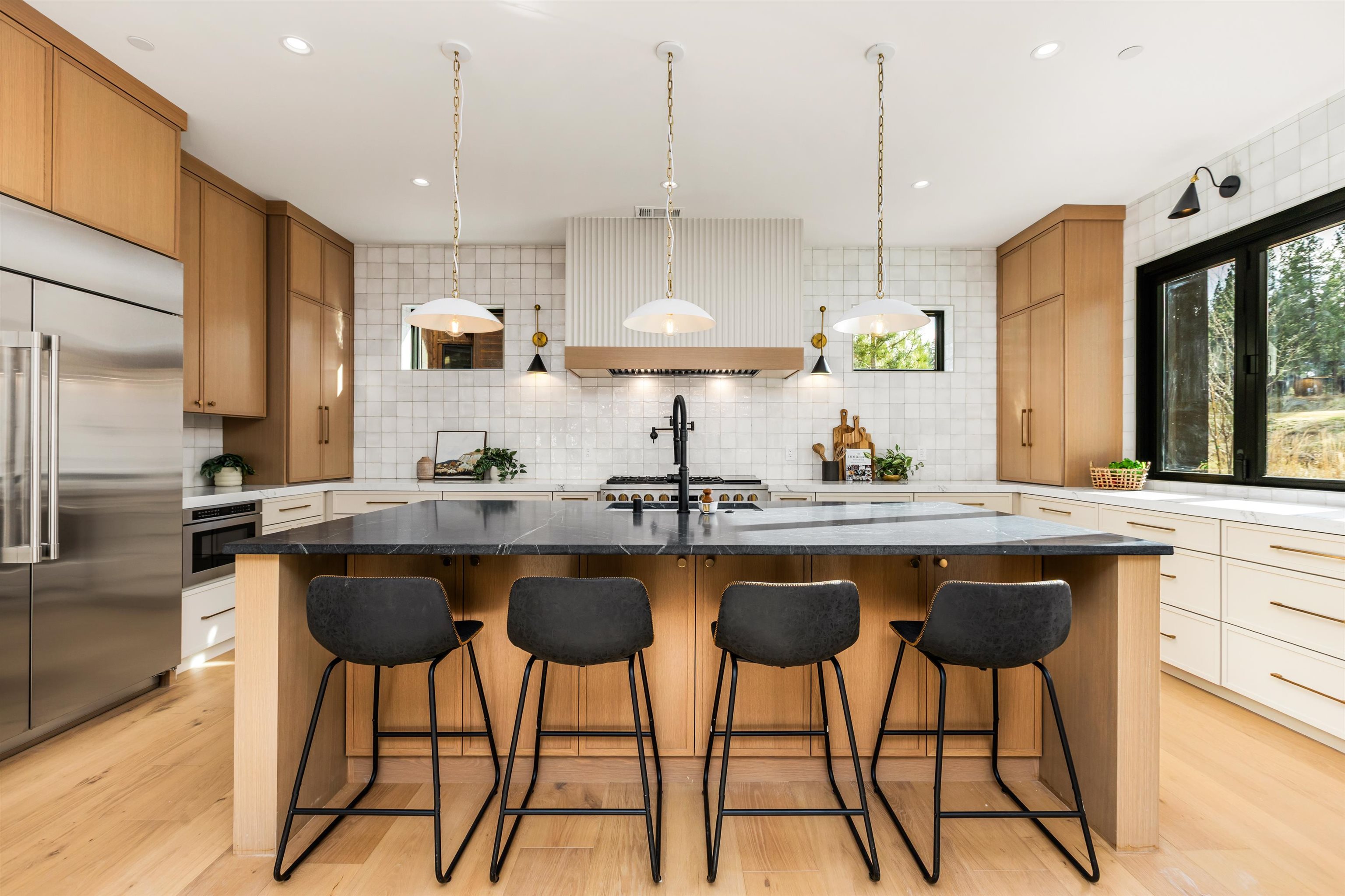 11051 Ghirard Road Truckee, CA 96161 - Photo 8 of 23 a kitchen with stainless steel appliances granite countertop a sink a stove a refrigerator and island with wooden floor