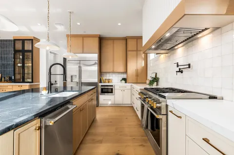 a kitchen with a stove a sink and a refrigerator