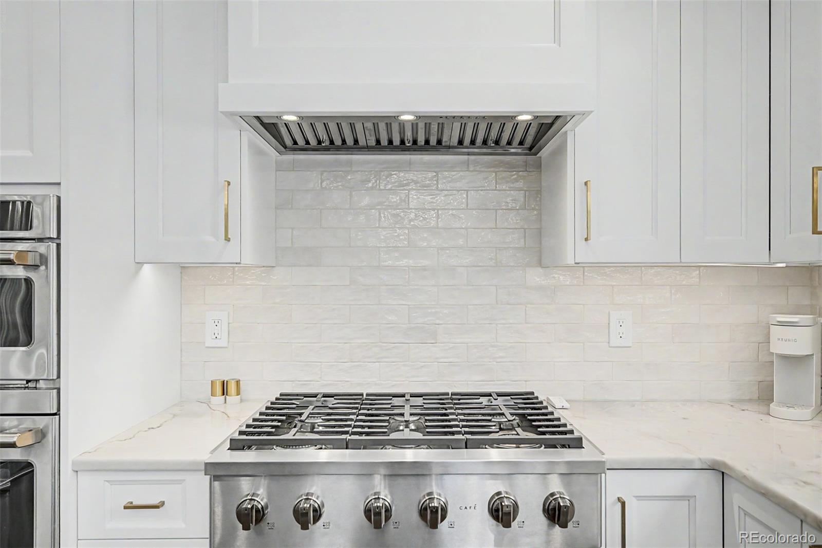 10246 South Spotted Owl Avenue Highlands Ranch, CO 80129 - Photo 15 of 49 a close view of a stove a microwave and cabinets