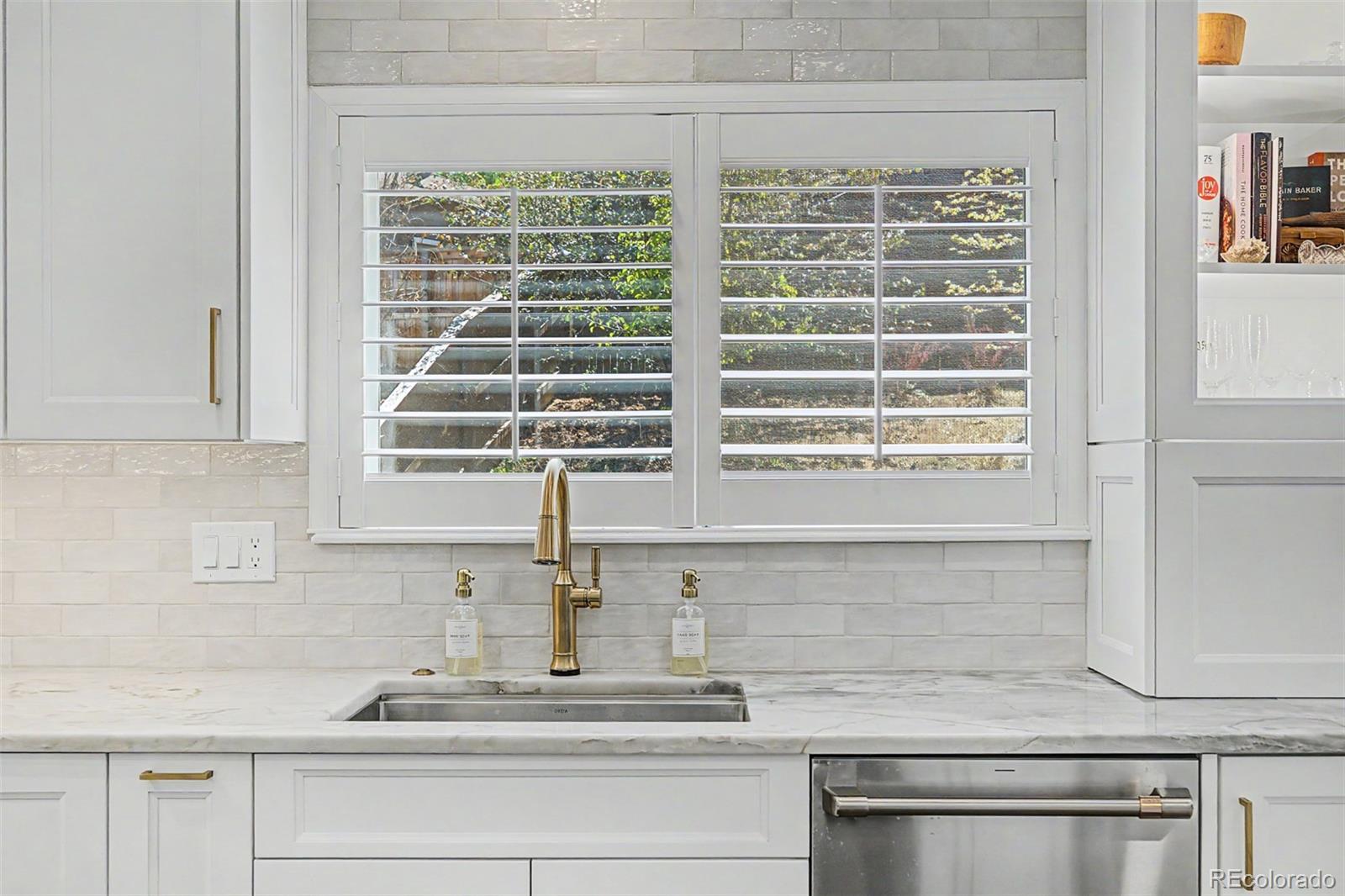 10246 South Spotted Owl Avenue Highlands Ranch, CO 80129 - Photo 19 of 49 a kitchen with a sink and a window