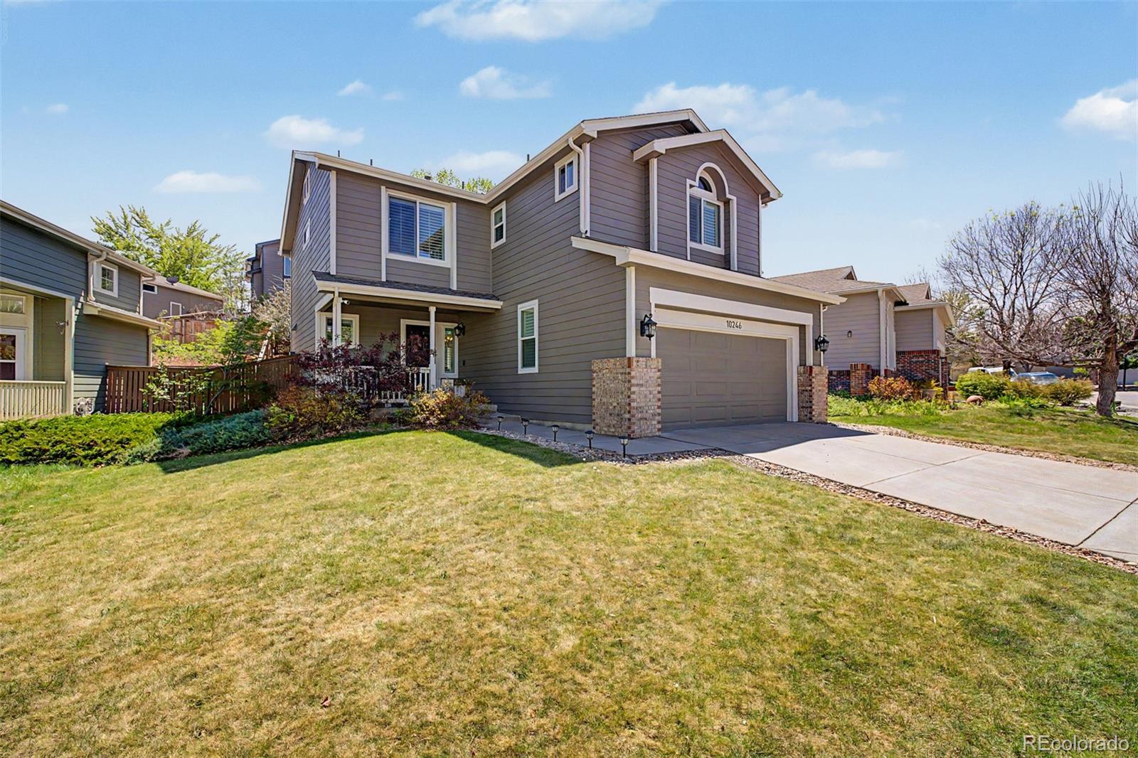 10246 South Spotted Owl Avenue Highlands Ranch, CO 80129 - Photo 2 of 49 a front view of a house with a yard and garage