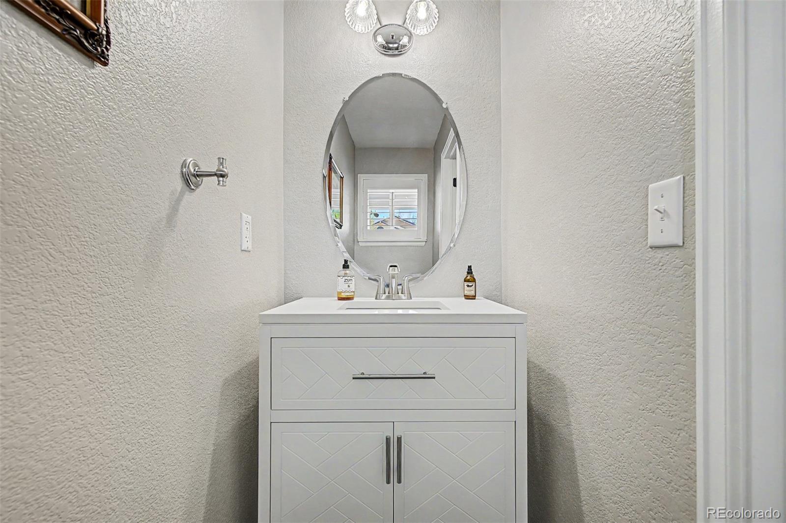 10246 South Spotted Owl Avenue Highlands Ranch, CO 80129 - Photo 21 of 49 a bathroom with a sink and a mirror