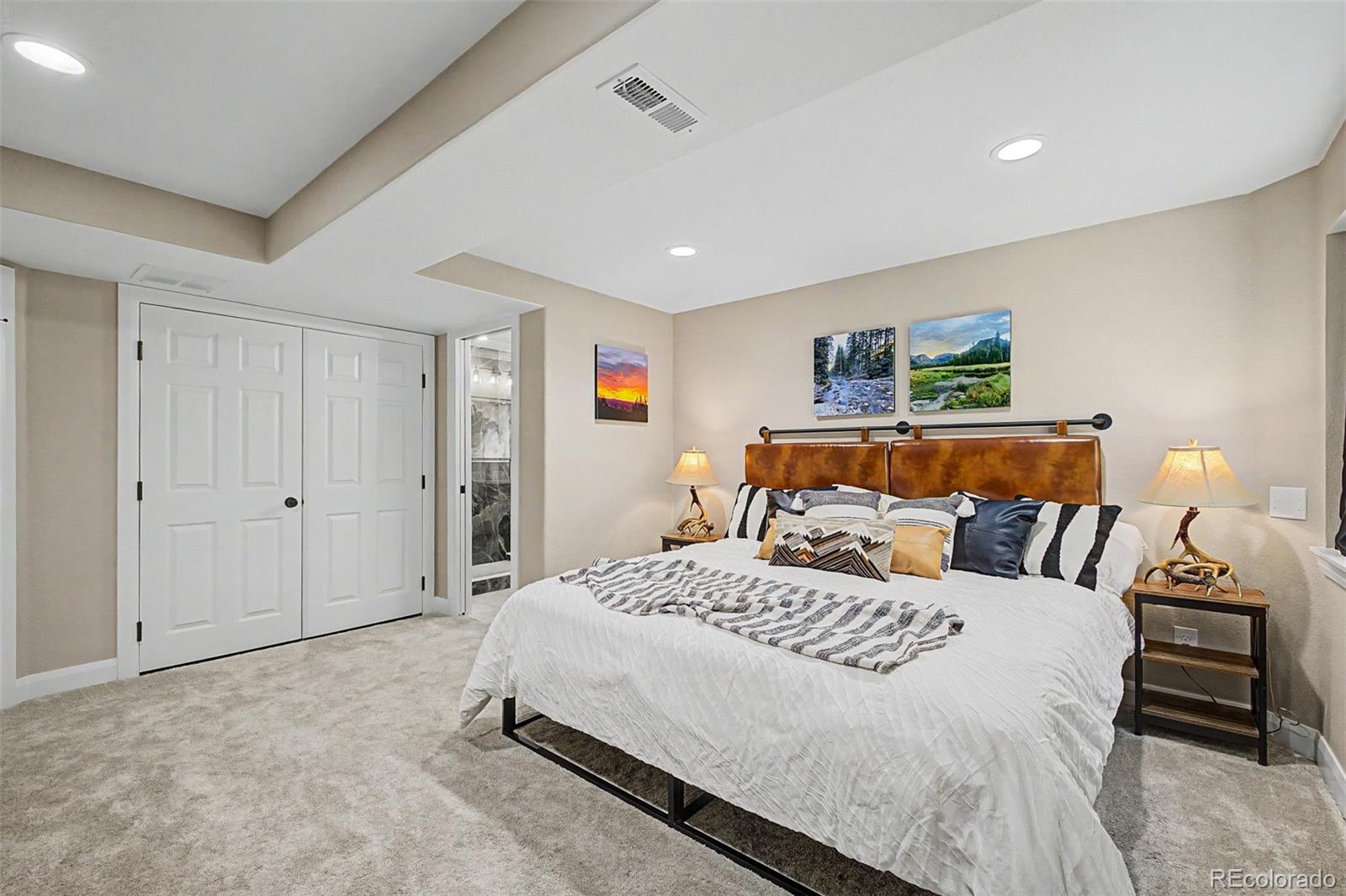 10246 South Spotted Owl Avenue Highlands Ranch, CO 80129 - Photo 22 of 49 a bedroom with a bed and a night stand