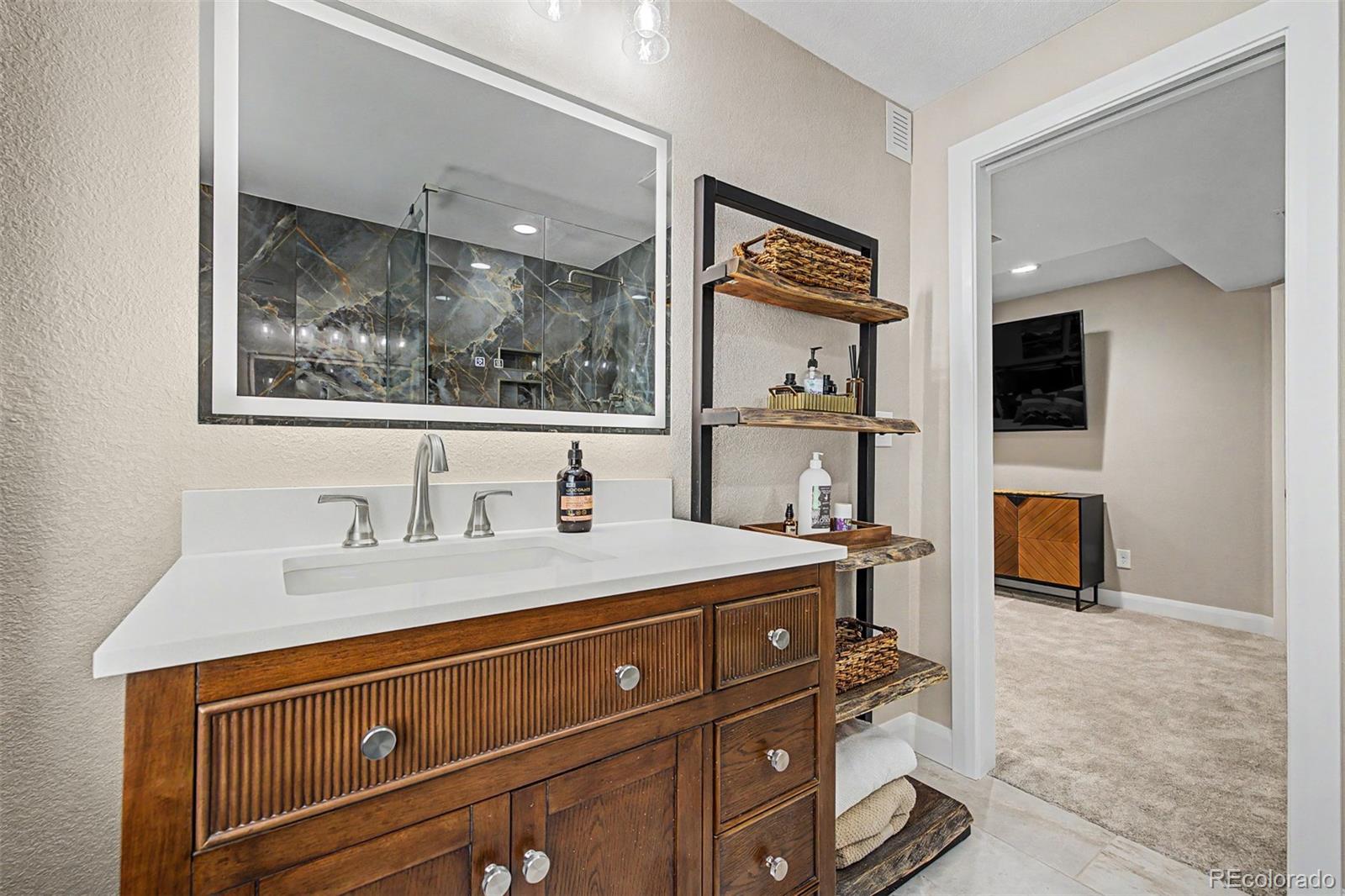 10246 South Spotted Owl Avenue Highlands Ranch, CO 80129 - Photo 26 of 49 a bathroom with a sink and a mirror