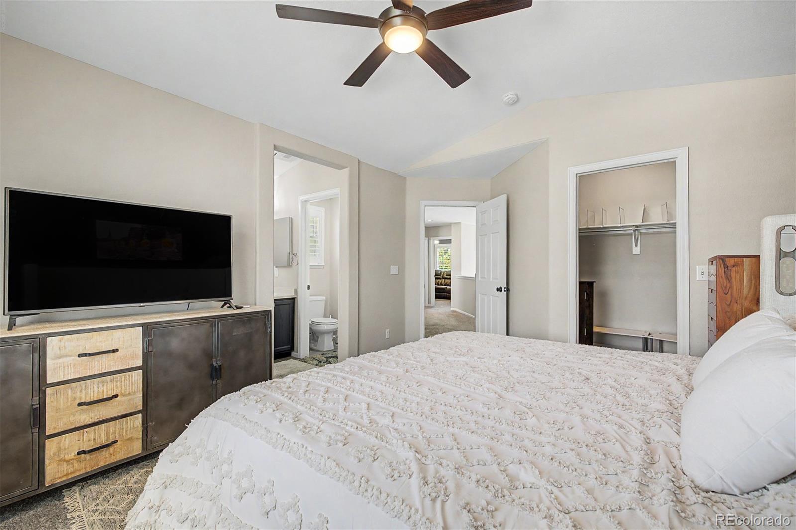 10246 South Spotted Owl Avenue Highlands Ranch, CO 80129 - Photo 29 of 49 a bedroom with a bed and a flat screen tv