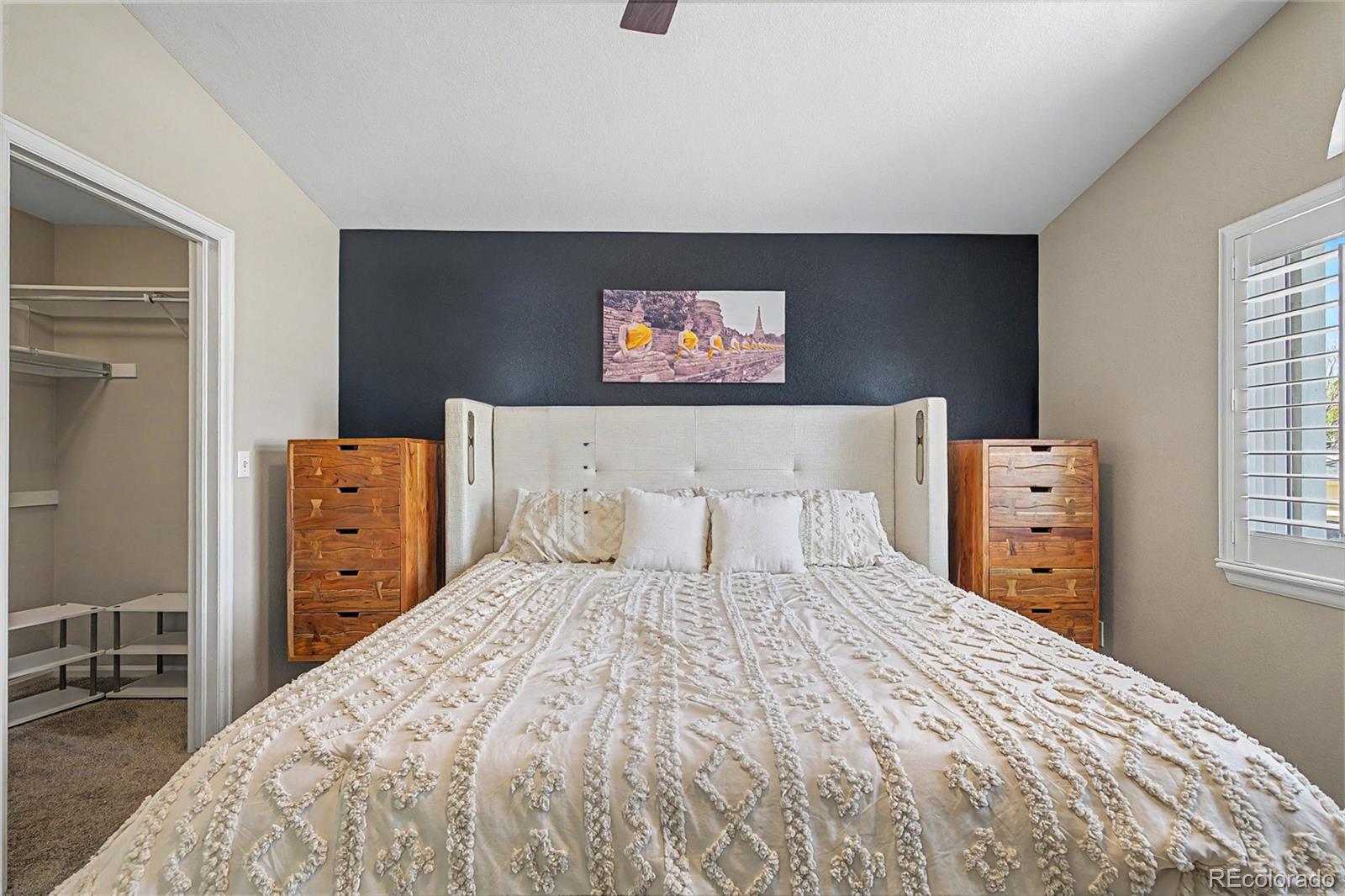 10246 South Spotted Owl Avenue Highlands Ranch, CO 80129 - Photo 30 of 49 a bedroom with a bed and a refrigerator