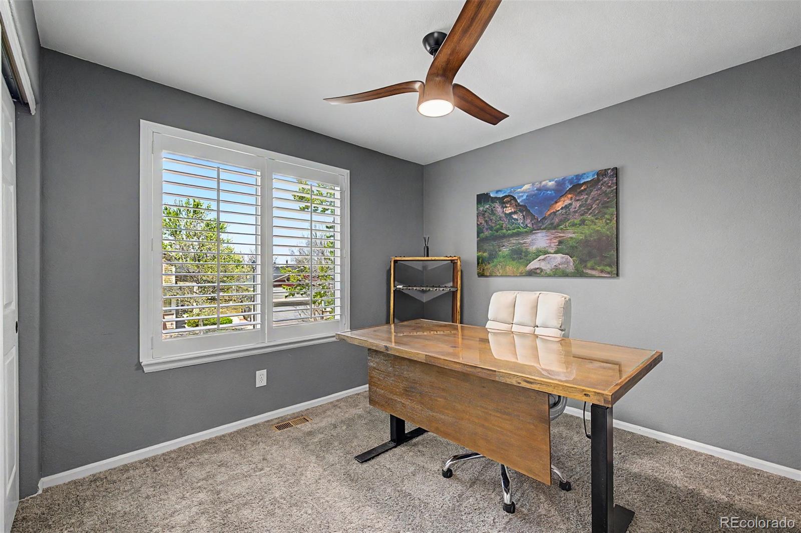 10246 South Spotted Owl Avenue Highlands Ranch, CO 80129 - Photo 32 of 49 a workspace with furniture and a window