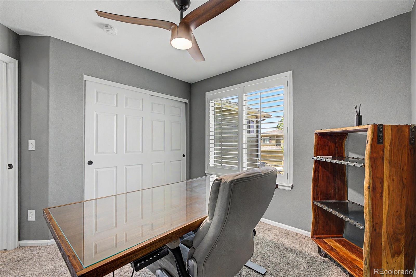 10246 South Spotted Owl Avenue Highlands Ranch, CO 80129 - Photo 33 of 49 a room with furniture and a window