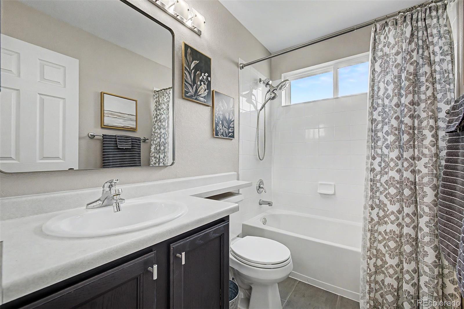 10246 South Spotted Owl Avenue Highlands Ranch, CO 80129 - Photo 34 of 49 a bathroom with a sink a toilet and shower
