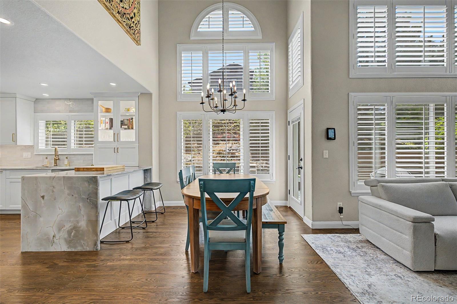 10246 South Spotted Owl Avenue Highlands Ranch, CO 80129 - Photo 7 of 49 a view of a dining room with furniture window and wooden floor