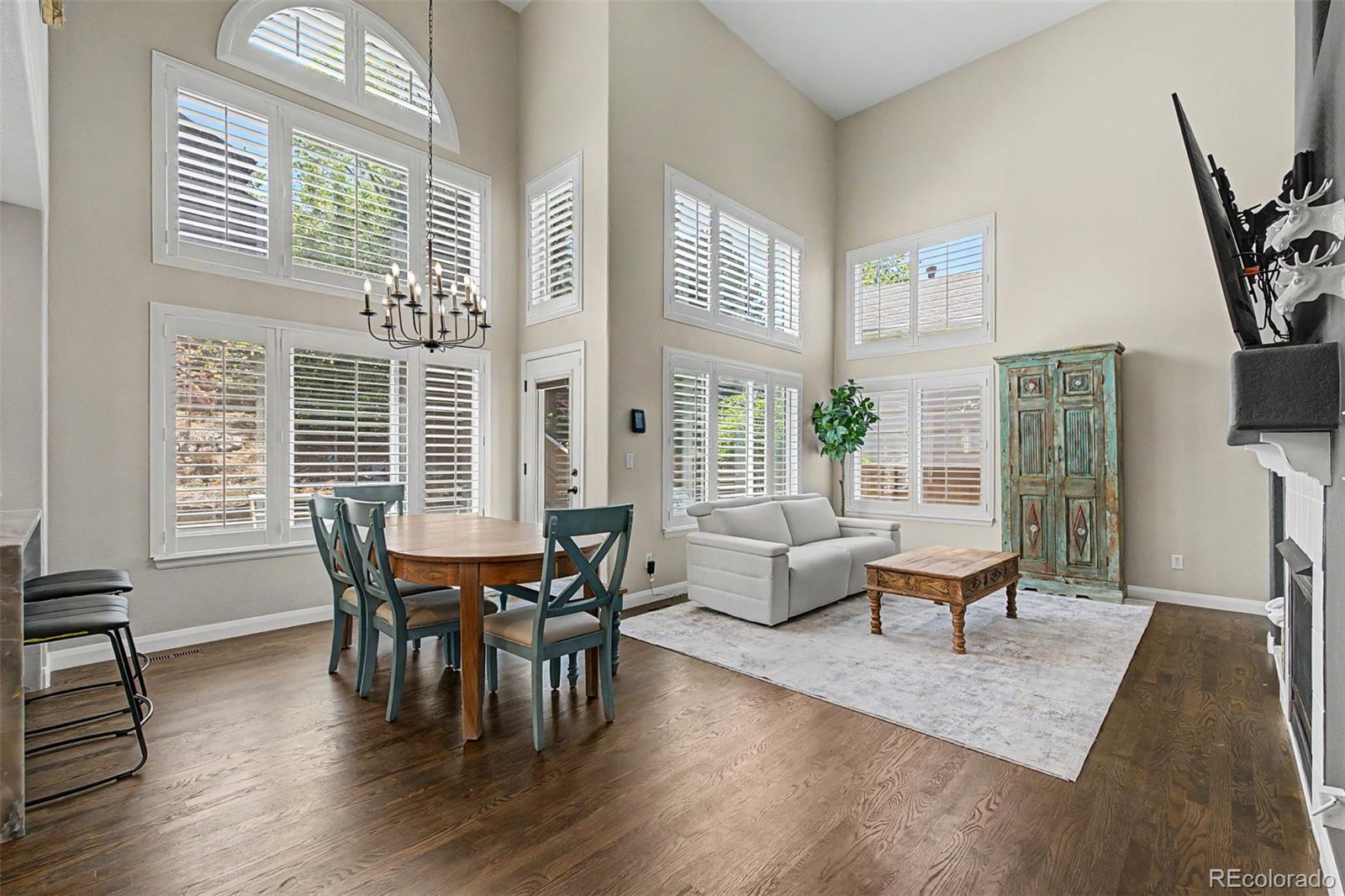 10246 South Spotted Owl Avenue Highlands Ranch, CO 80129 - Photo 8 of 49 a view of a dining room with furniture window and wooden floor