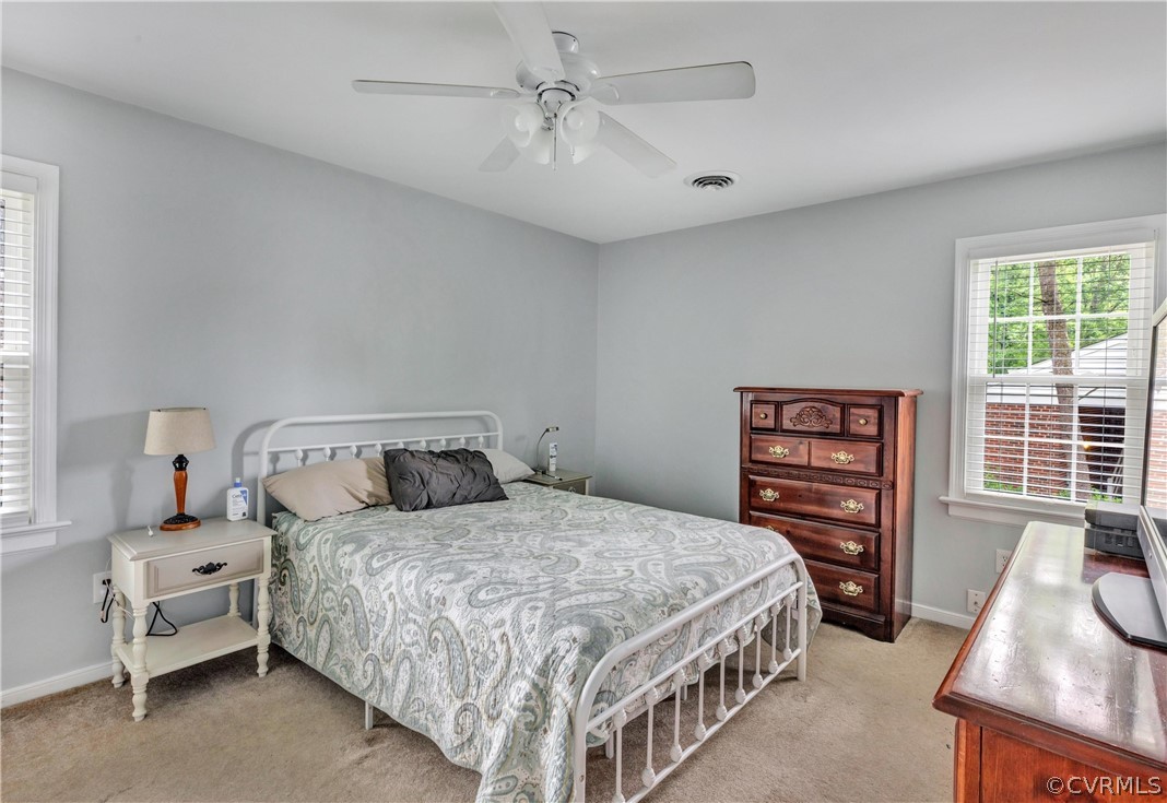 4801 Wilconna Road Chesterfield, VA 23832 - Photo 18 of 25 a bedroom with a bed a chandelier and a dresser