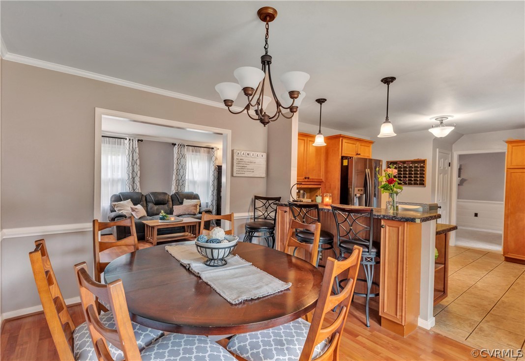 4801 Wilconna Road Chesterfield, VA 23832 - Photo 8 of 25 a view of a dining room and livingroom with furniture wooden floor a chandelier