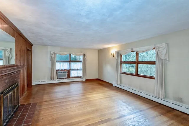 wooden floor in an empty room with a window
