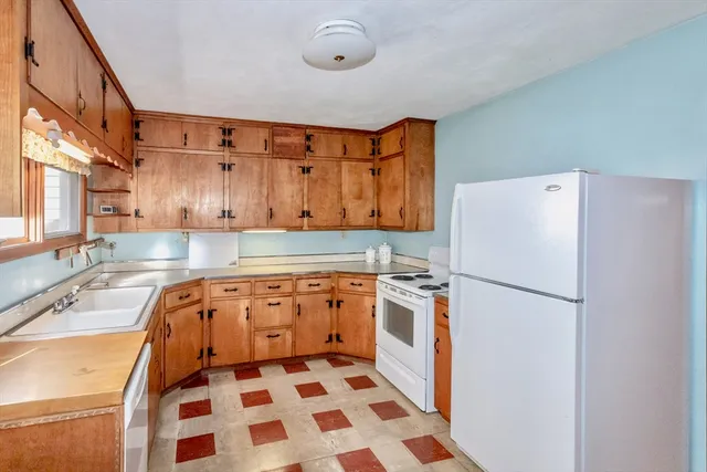 a kitchen with stainless steel appliances granite countertop a refrigerator and a stove