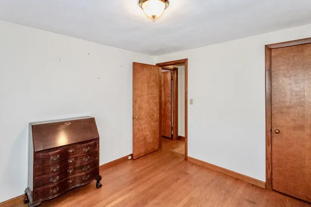 a view of room with wooden floor and window
